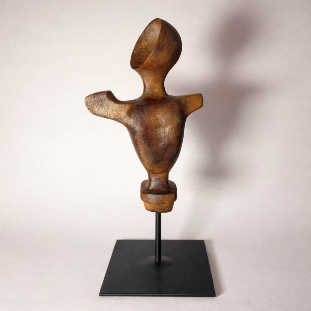 Faceless figure sculpture in wood-toned PLA mounted on black cylindrical base with metal support